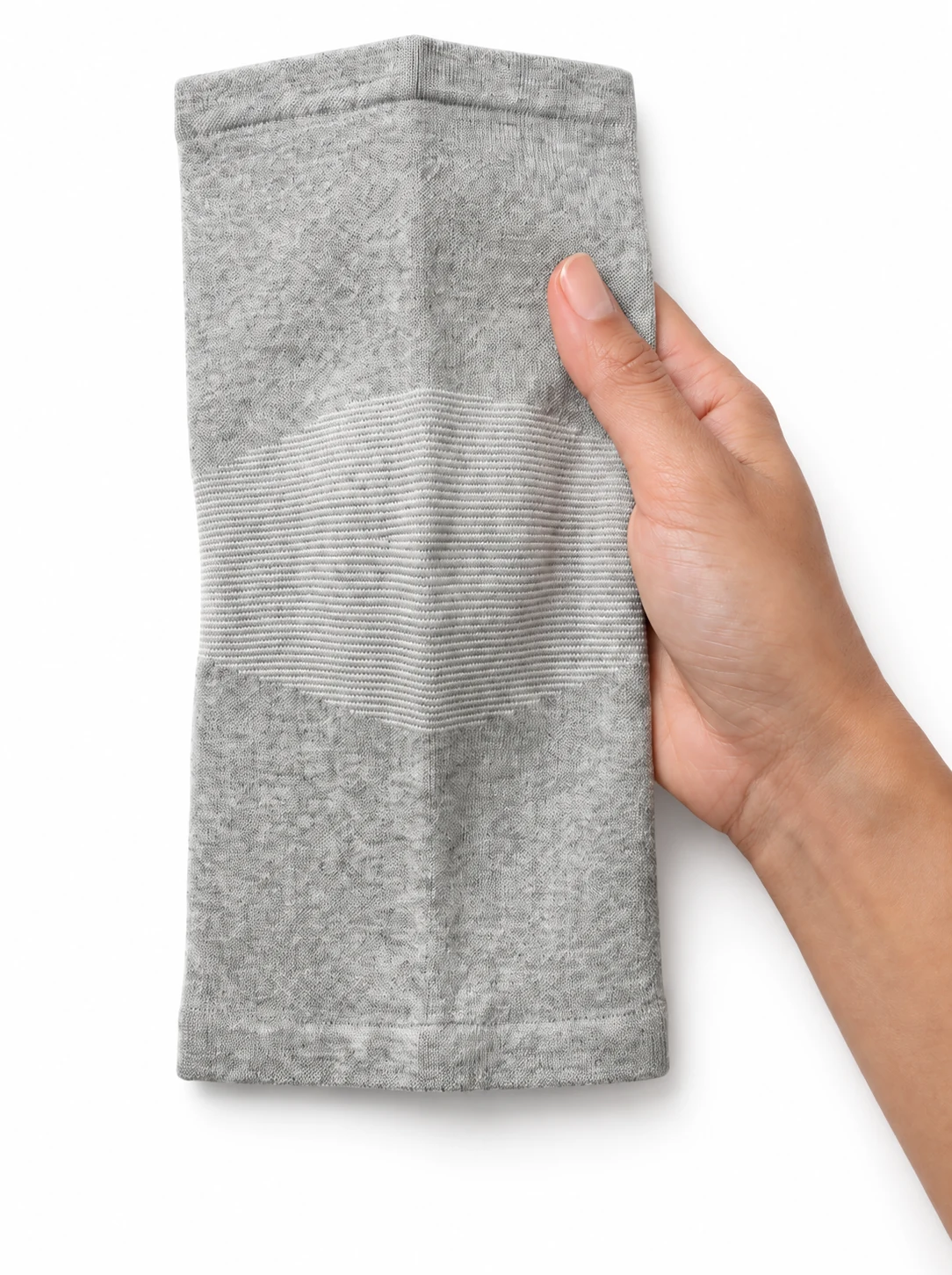 A gray knee sleeve held in one hand